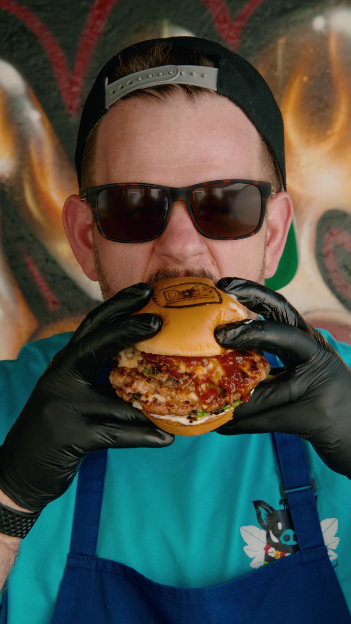 Simon Woods, the Woodsman Smoke Shack pitmaster, holding a barbecue burger
